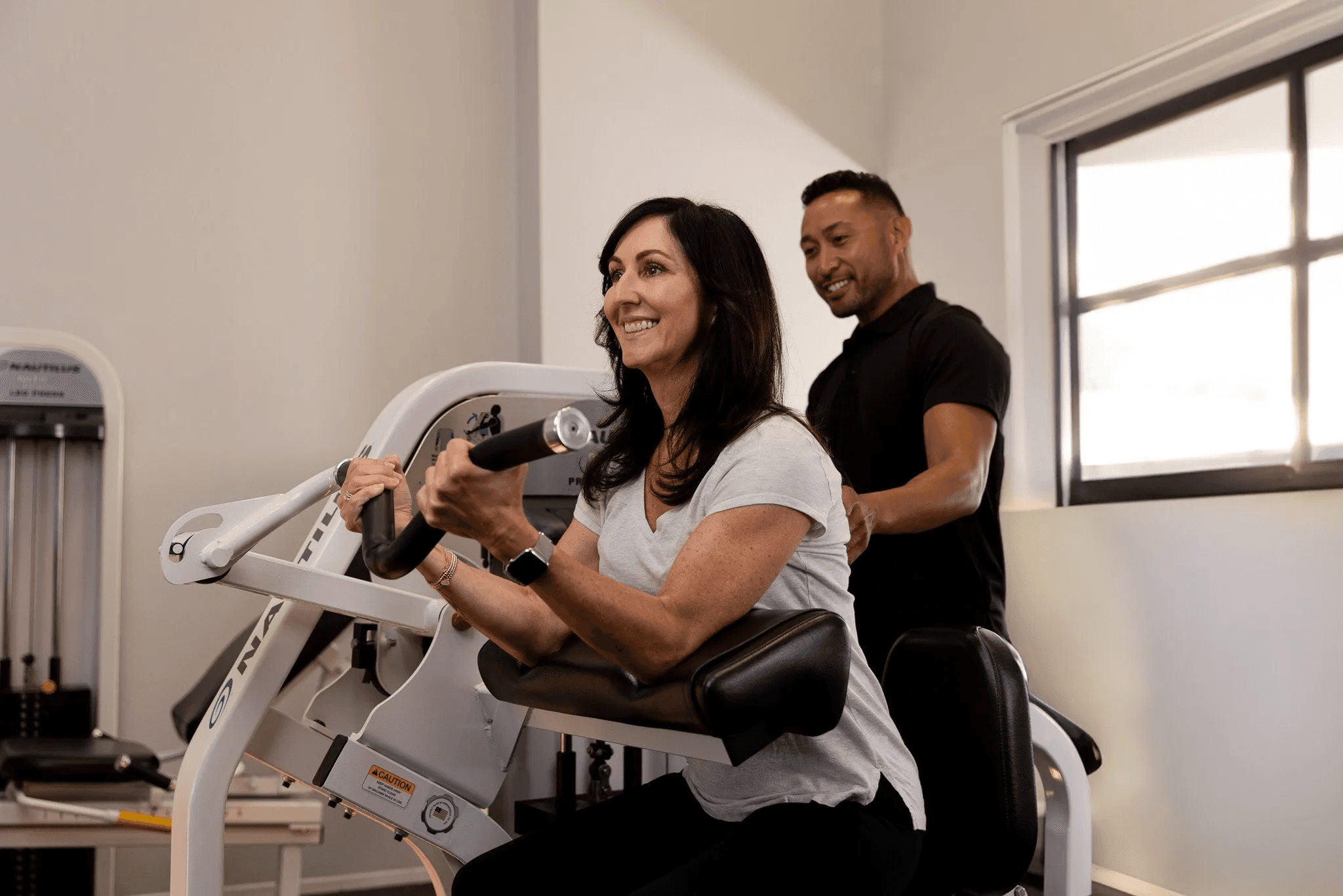 A customer and trainer at one of The Perfect Workout's studios