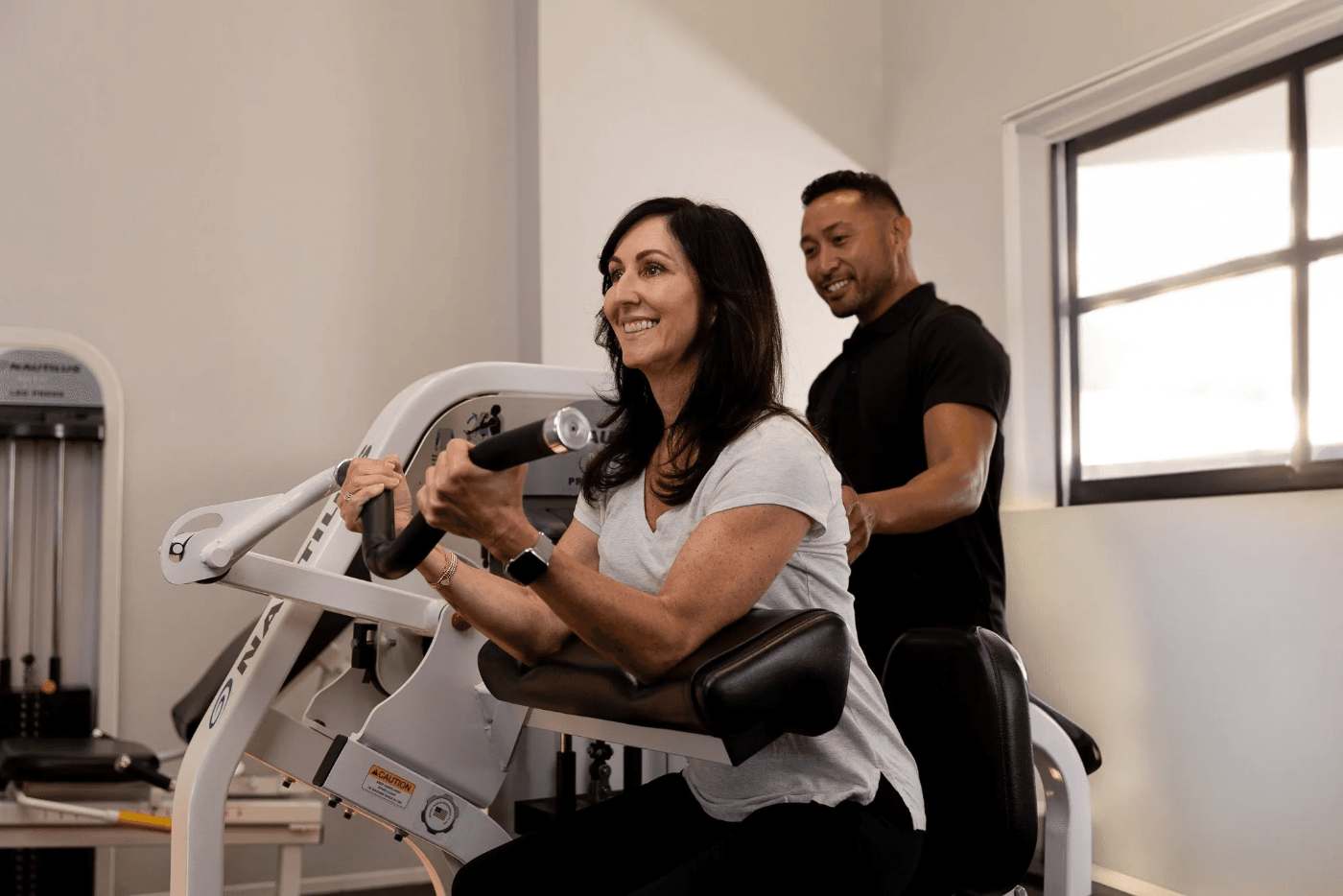 A customer and trainer at one of The Perfect Workout's studios